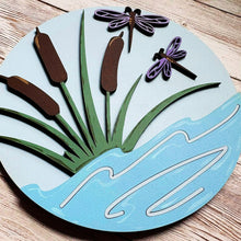 Load image into Gallery viewer, Layered interchangeable frame insert featuring a blue pond with cattails and purple dragonflies in a soft, nature-inspired design.