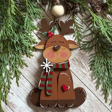 Load image into Gallery viewer, Adorable hand-painted sitting reindeer ornament, capturing holiday whimsy and charm for festive décor.