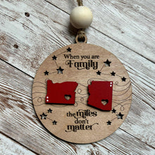 Load image into Gallery viewer, Custom ornament featuring two states with hearts, celebrating family, friends, or loved ones across the miles.
