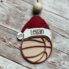 Load image into Gallery viewer, Basketball: Personalized basketball ornament with Santa hat and custom name, Christmas tree décor.

Baseball: Hand-painted baseball ornament with Santa hat and athlete name, holiday gift.

Soccer: Personalized soccer ornament with Santa hat and player name, festive Christmas ornament.

Volleyball: Volleyball ornament with Santa hat and custom name, handmade holiday décor.

Football: Personalized football ornament with Santa hat and athlete name, rustic Christmas ornament.
